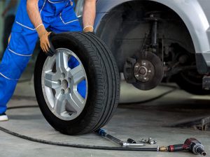 Mechanic pouring oil into an engine